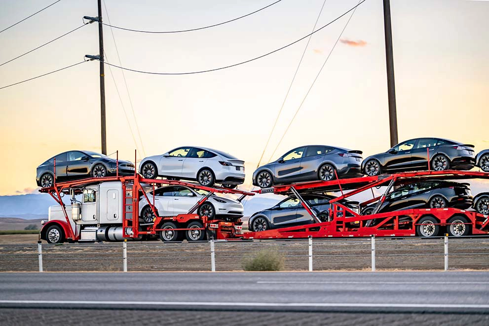 Open car carrier transporting vehicles through Washington