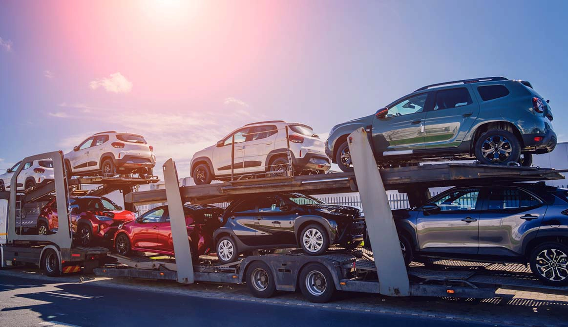 Multiple vehicles loaded on a car carrier for dealership transport