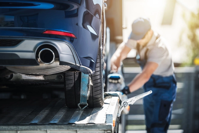 Auto transport carrier securing a vehicle to trailer